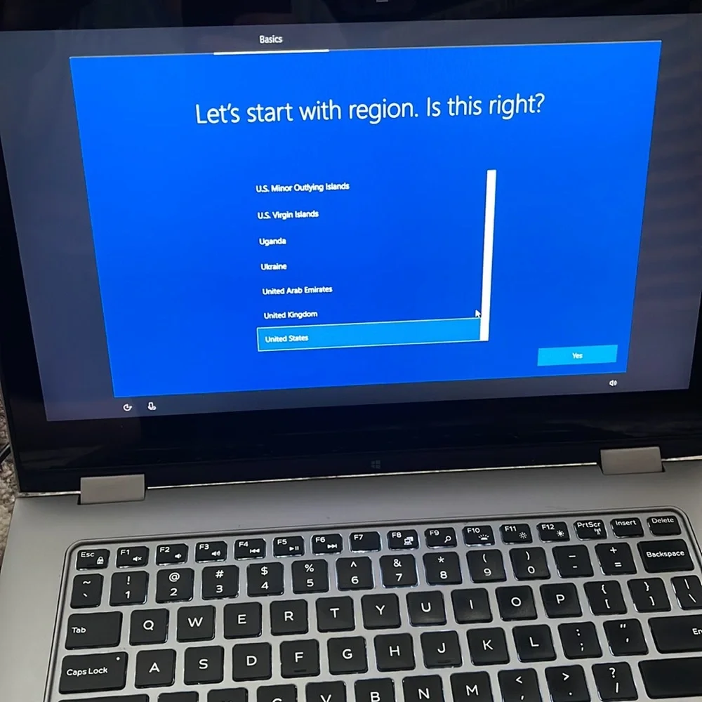 Silver Dell laptop that folds over to a tablet